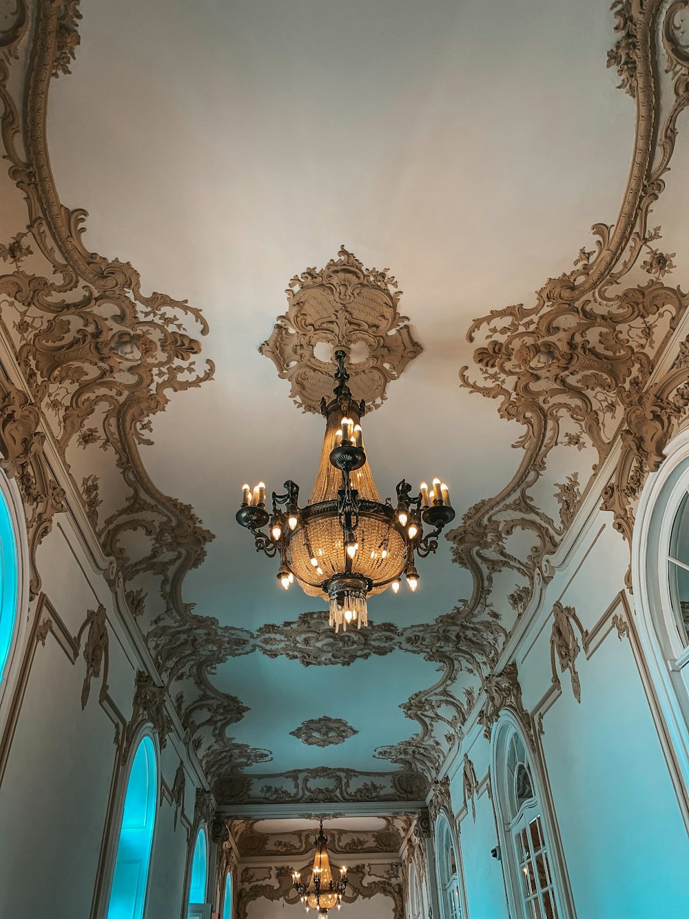 a hallway with a chandelier hanging from the ceiling