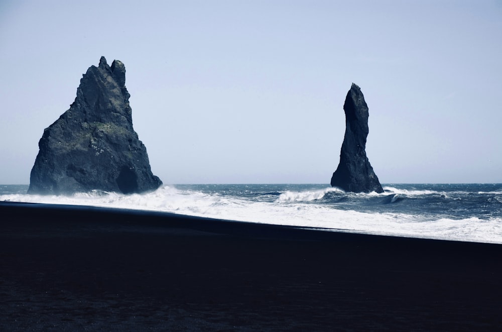 two large rocks sticking out of the ocean