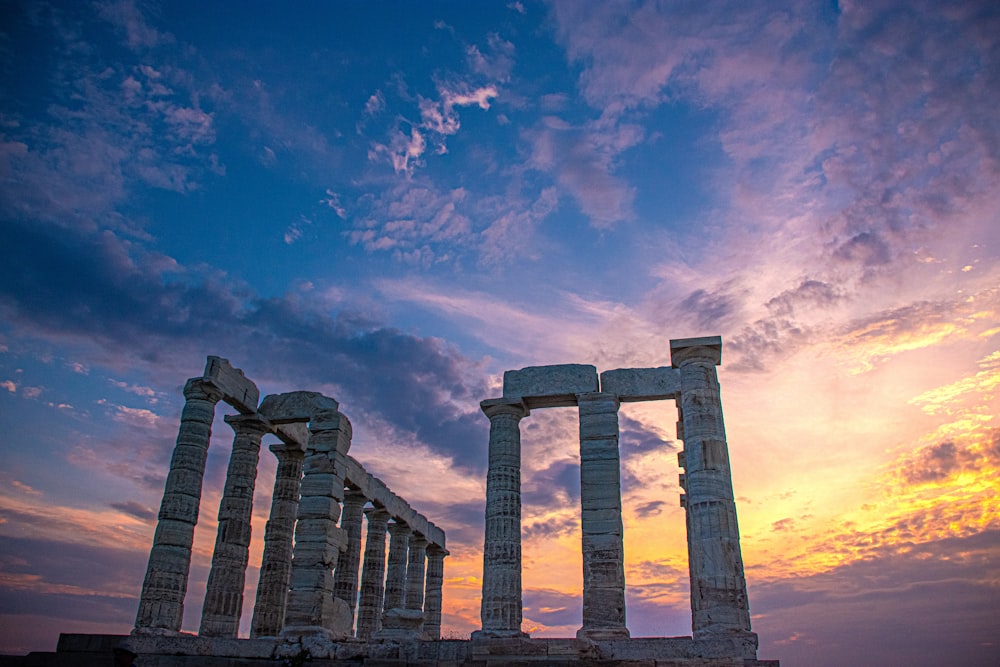 a group of stone pillars sitting on top of a field