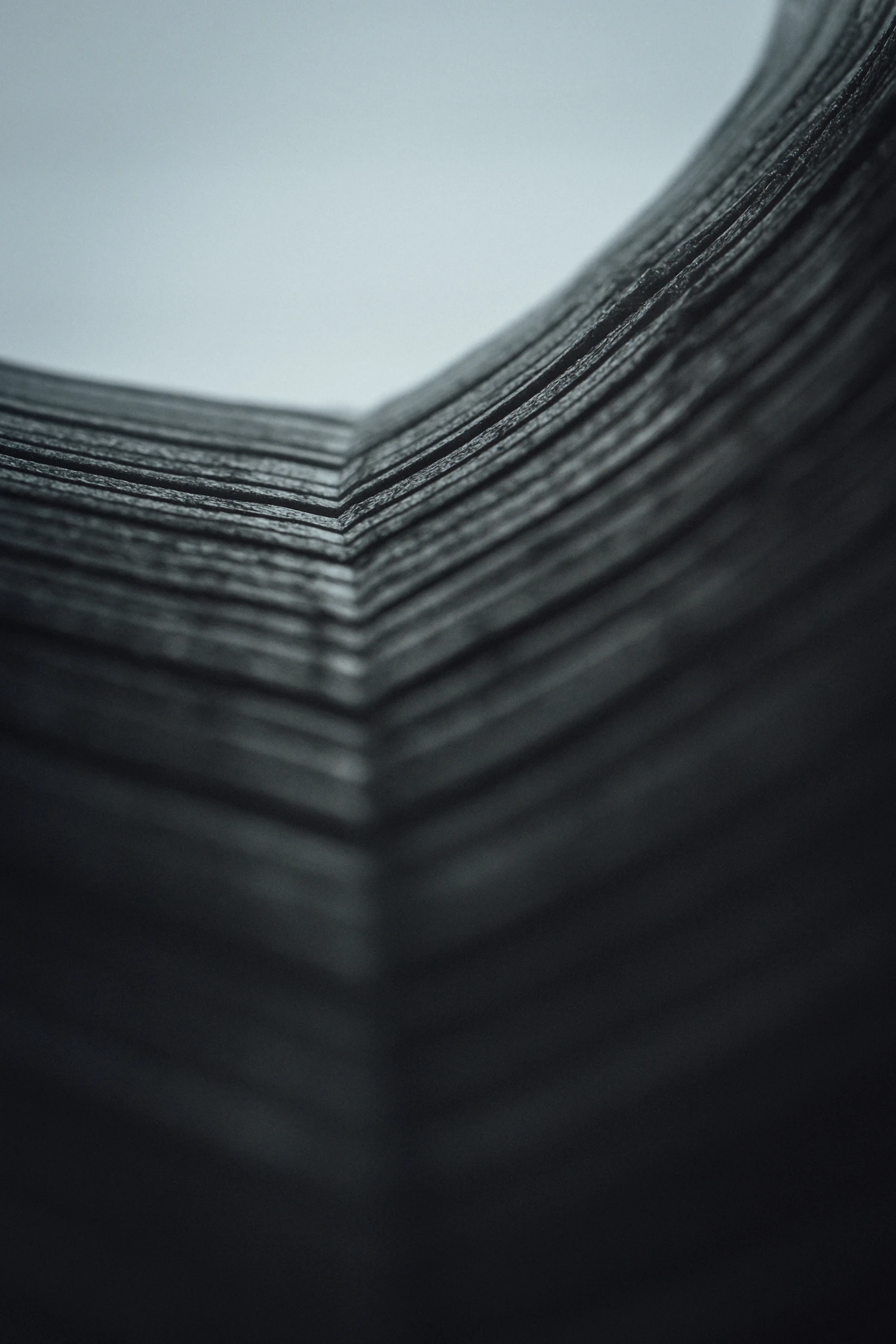 The corner of a thick block of paper photographed close