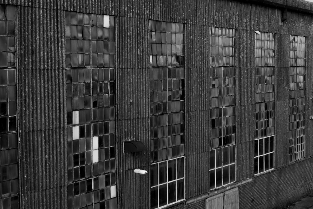 a black and white photo of windows on a building