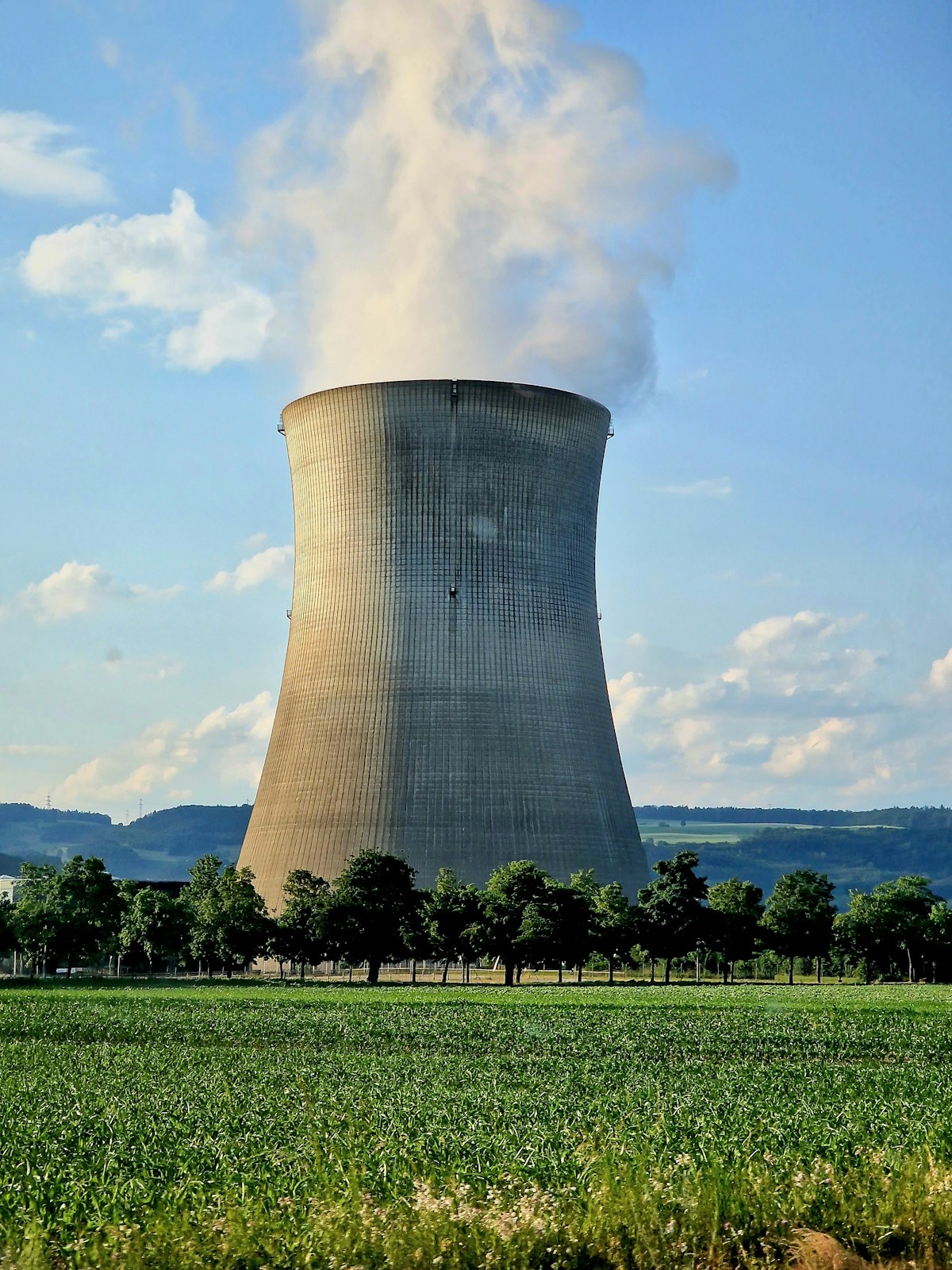 Nuclear power plant cooling towers against a blue sky