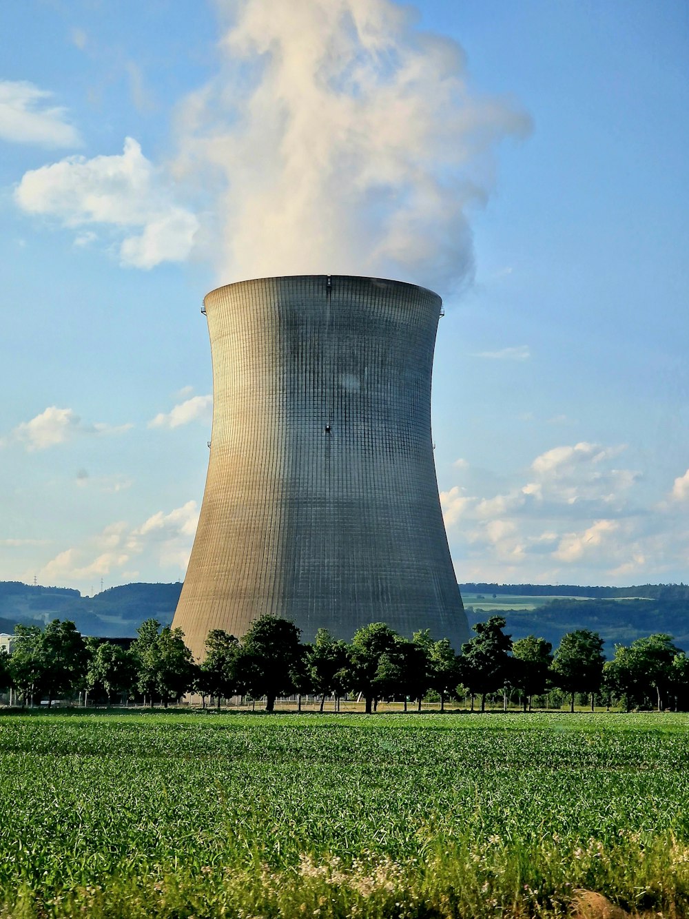 a nuclear power plant emitting smoke into the sky