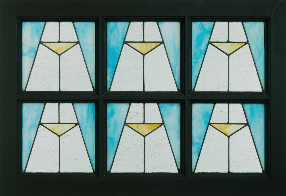 a set of four stained glass windows in a building