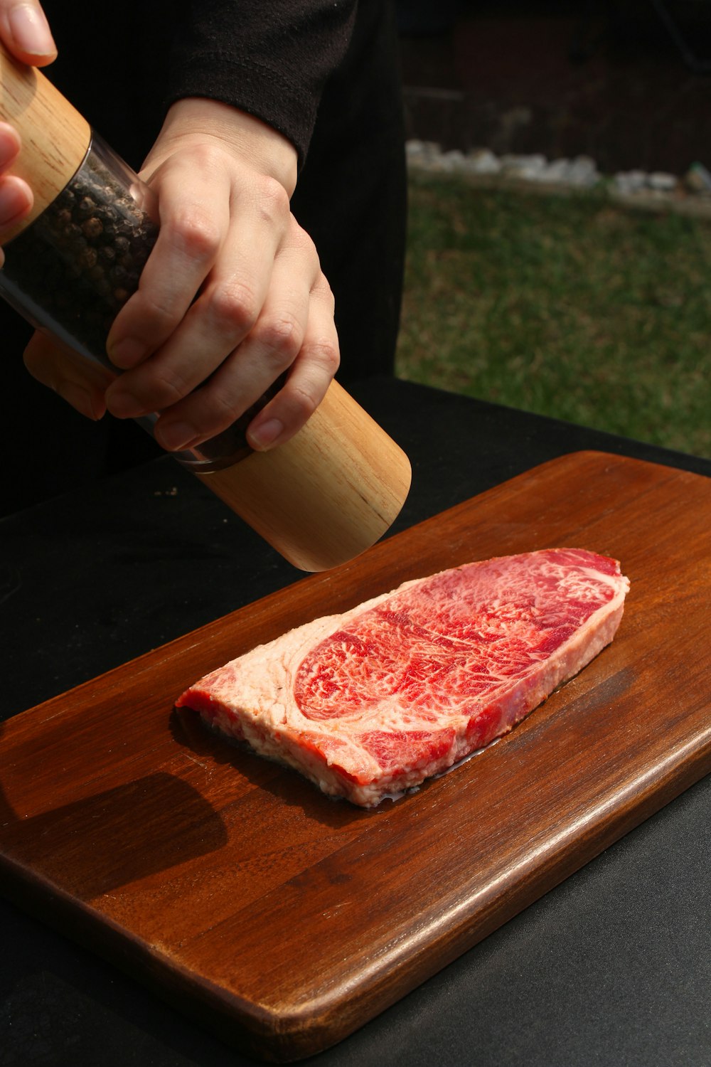 a piece of raw meat being prepared on a cutting board