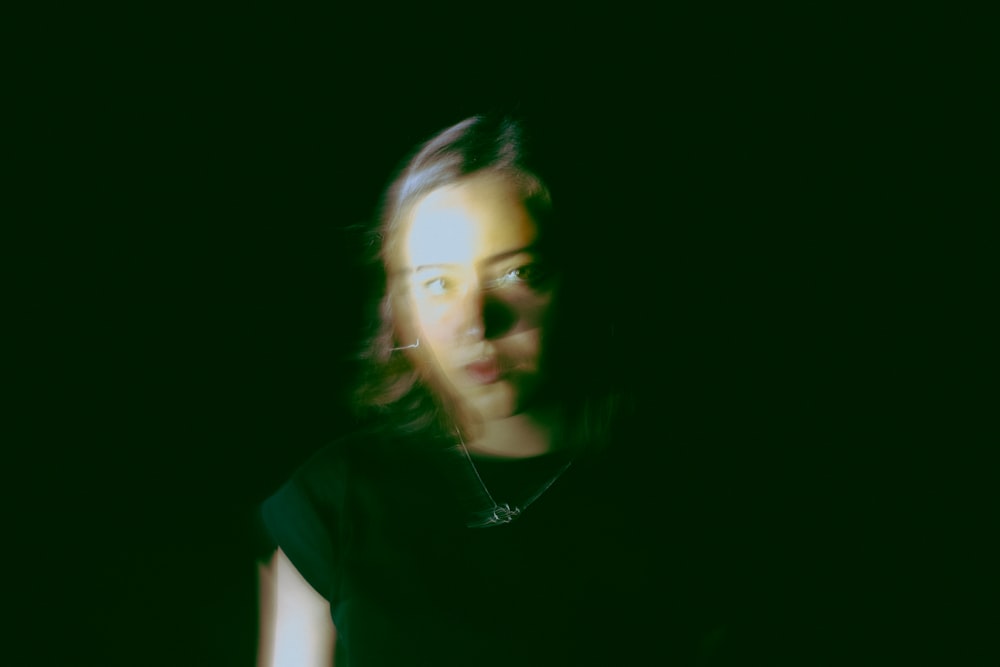 a blurry photo of a woman in a black shirt