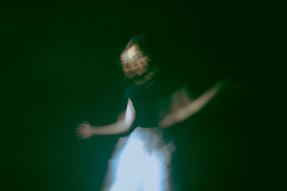 a blurry image of a woman in a black shirt