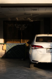 a white car parked in front of a building