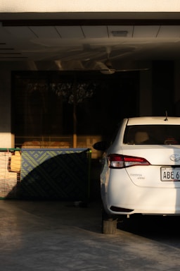 a white car parked in front of a building