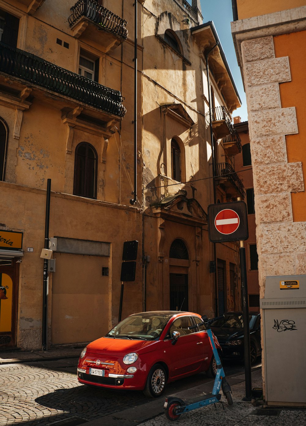 a red car parked on the side of a street