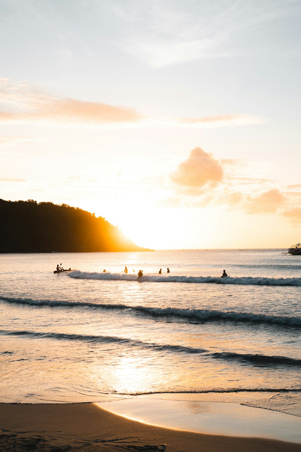 a group of people riding surfboards on top of a body of water