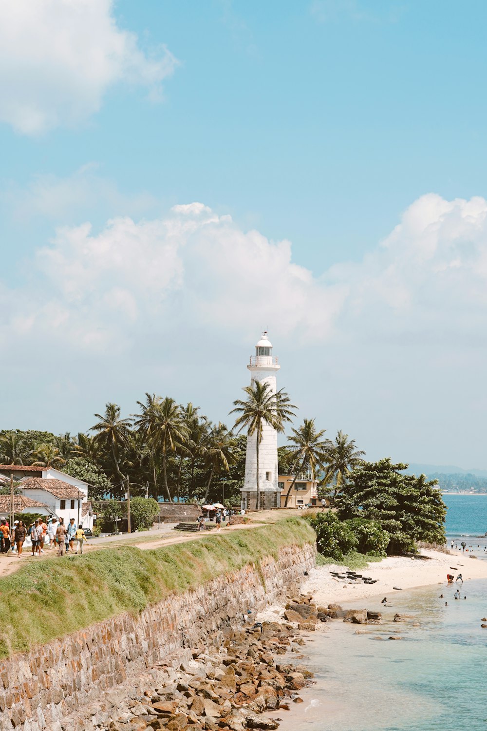 a light house on the shore of a beach