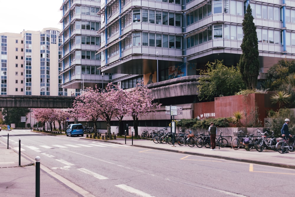 a city street lined with tall buildings and bicycles