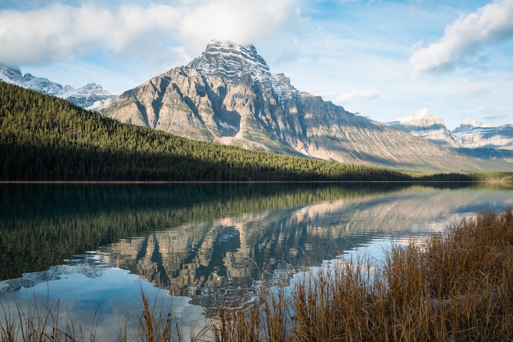 a mountain is reflected in the still water of a lake