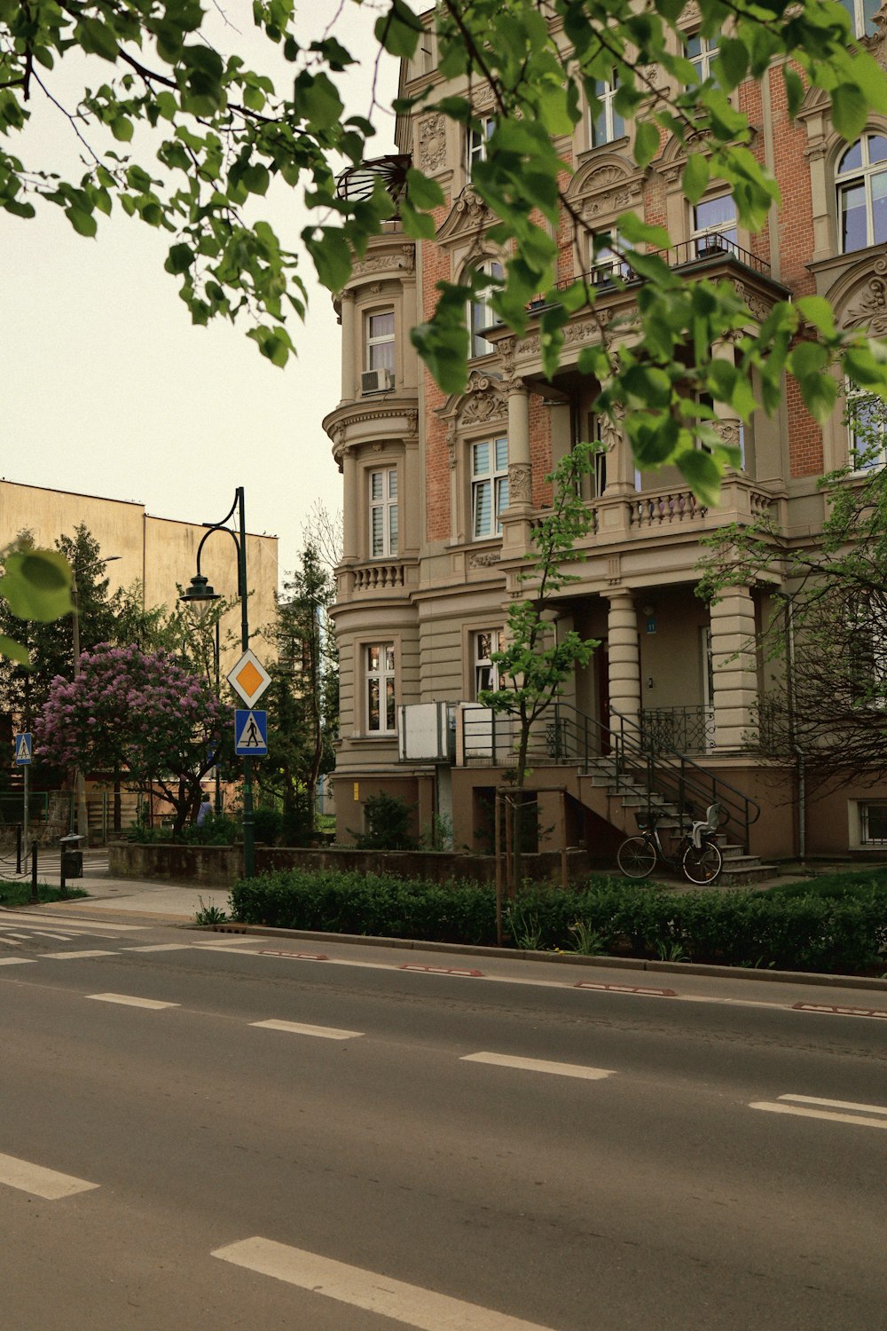 a city street with a tall building in the background