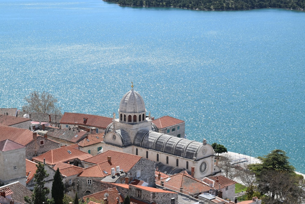 an aerial view of a city with a lake in the background