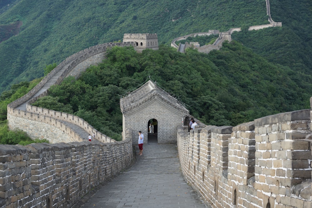 a large stone wall with a walkway leading to it