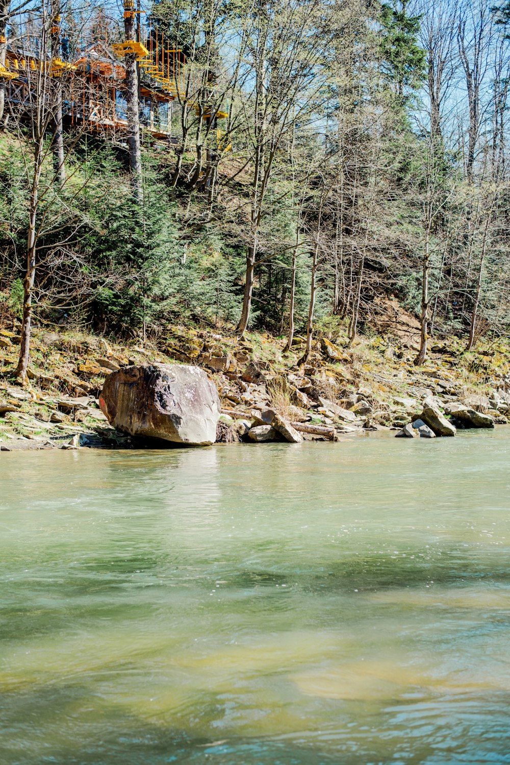 a large rock sitting in the middle of a river