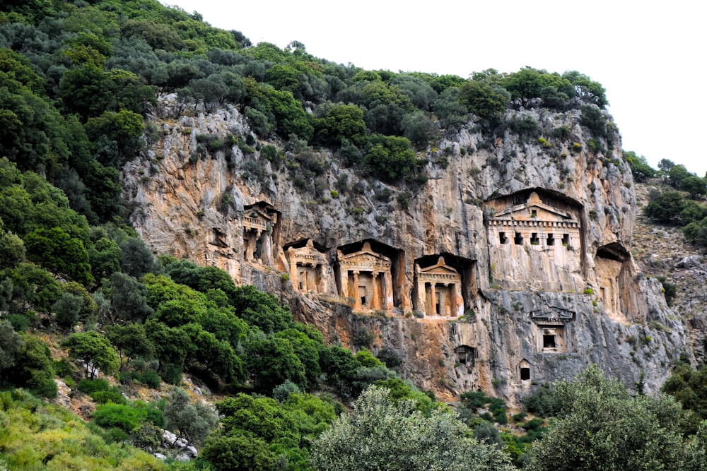 a mountain side with a bunch of buildings built into the side of it