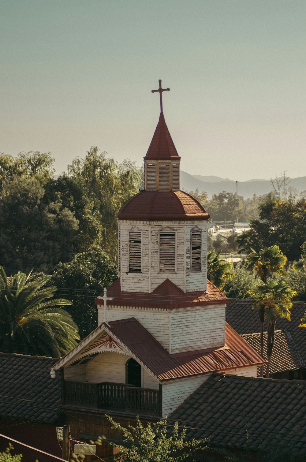 a church steeple with a cross on top of it