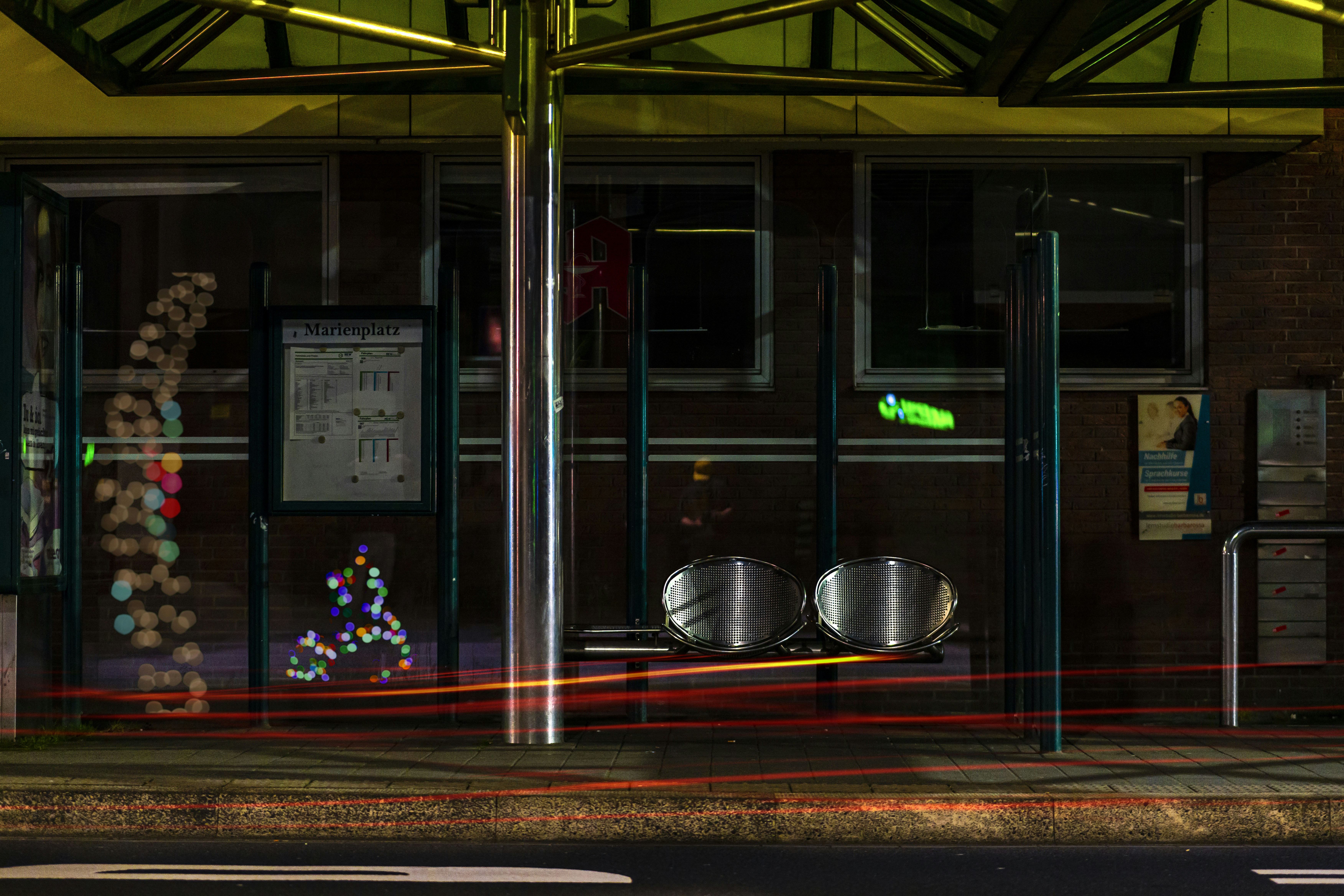 Bus stop shelter beside a tall building