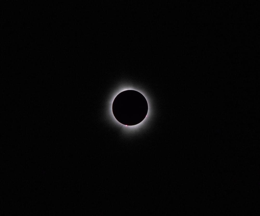 a solar eclipse is seen in the dark sky