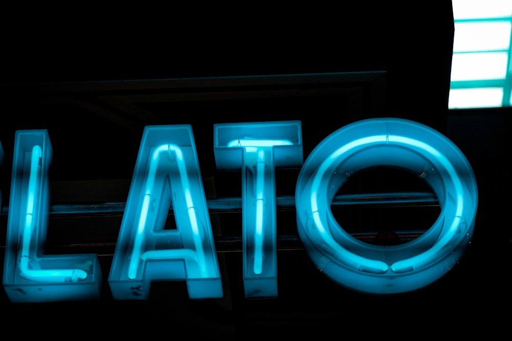 a blue neon sign that reads elato