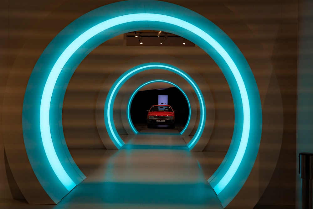 a car driving through a tunnel with blue lights