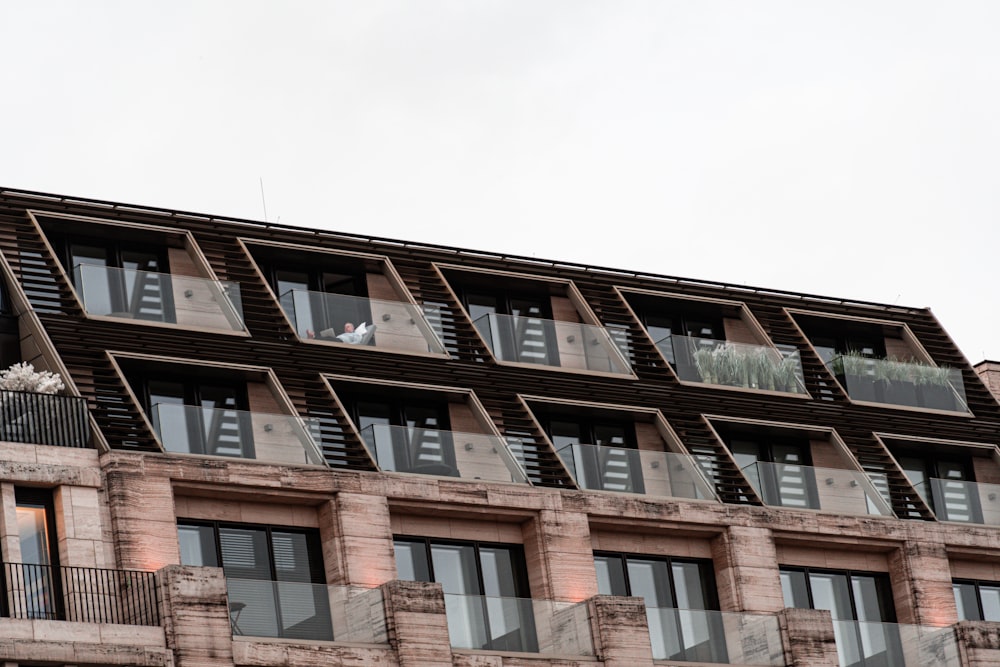 a tall building with many windows and balconies