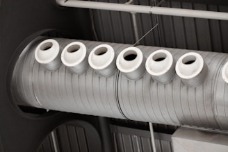 a row of white cups sitting on top of a machine
