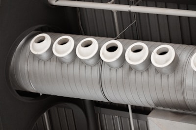 a row of white cups sitting on top of a machine