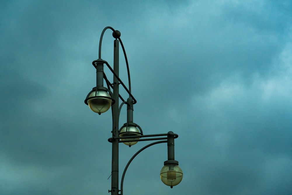 a street light with a cloudy sky in the background