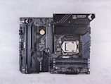 a close up of a computer motherboard on a white surface