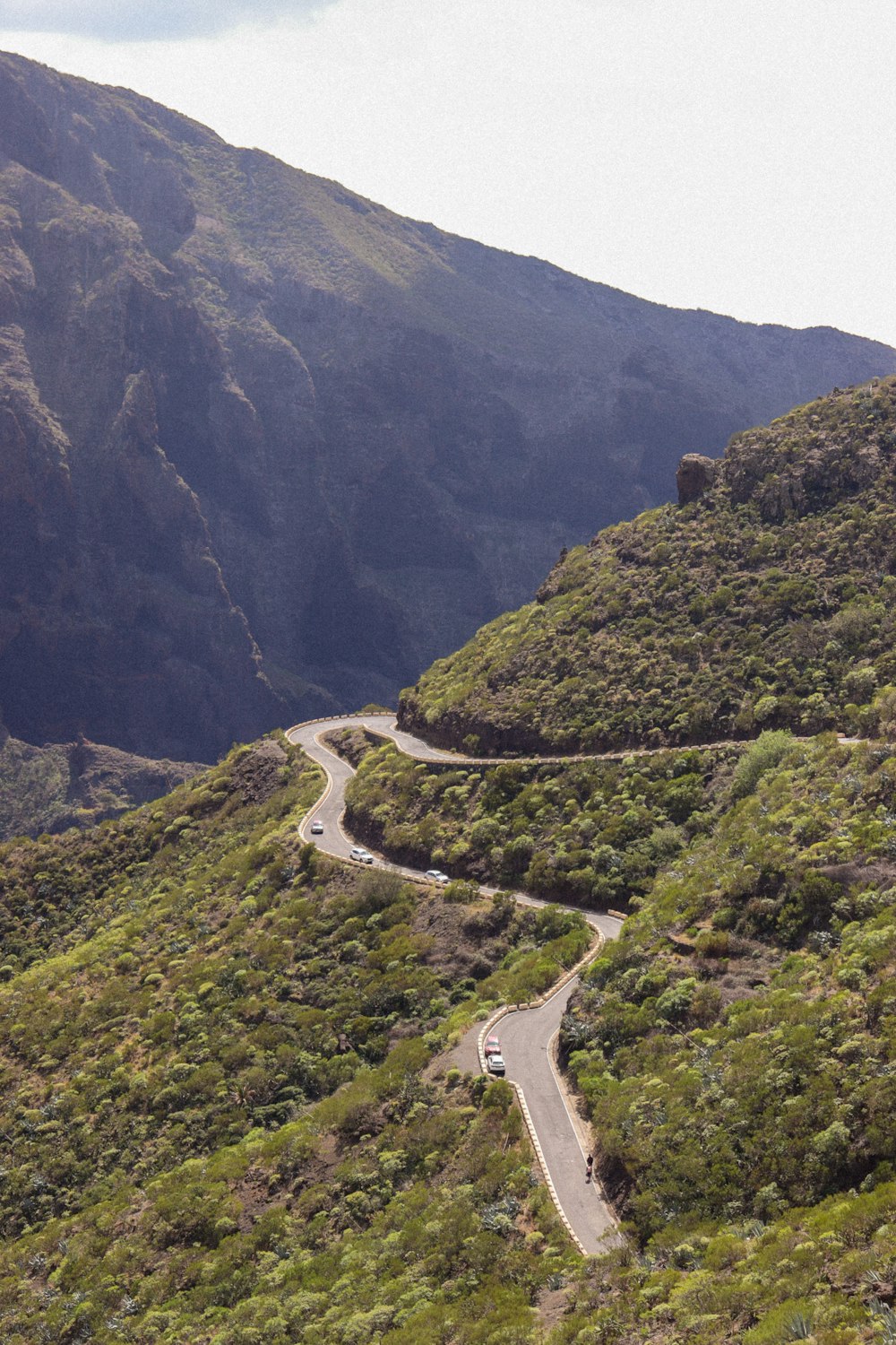 a car driving down a winding road in the mountains