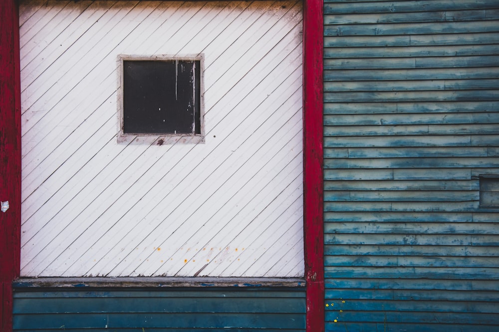 a red and blue building with a window