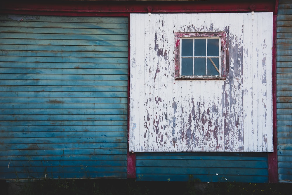 a blue building with a window on the side of it