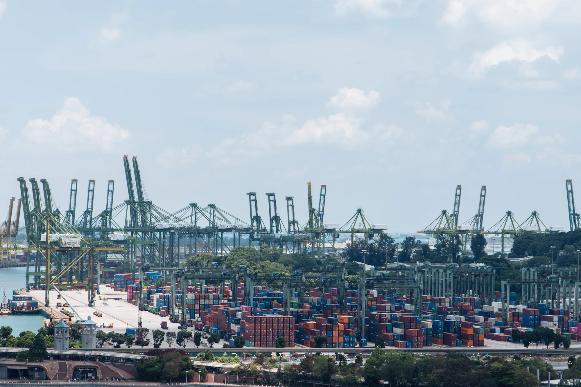 Harbor filled with container cranes and stacked containers