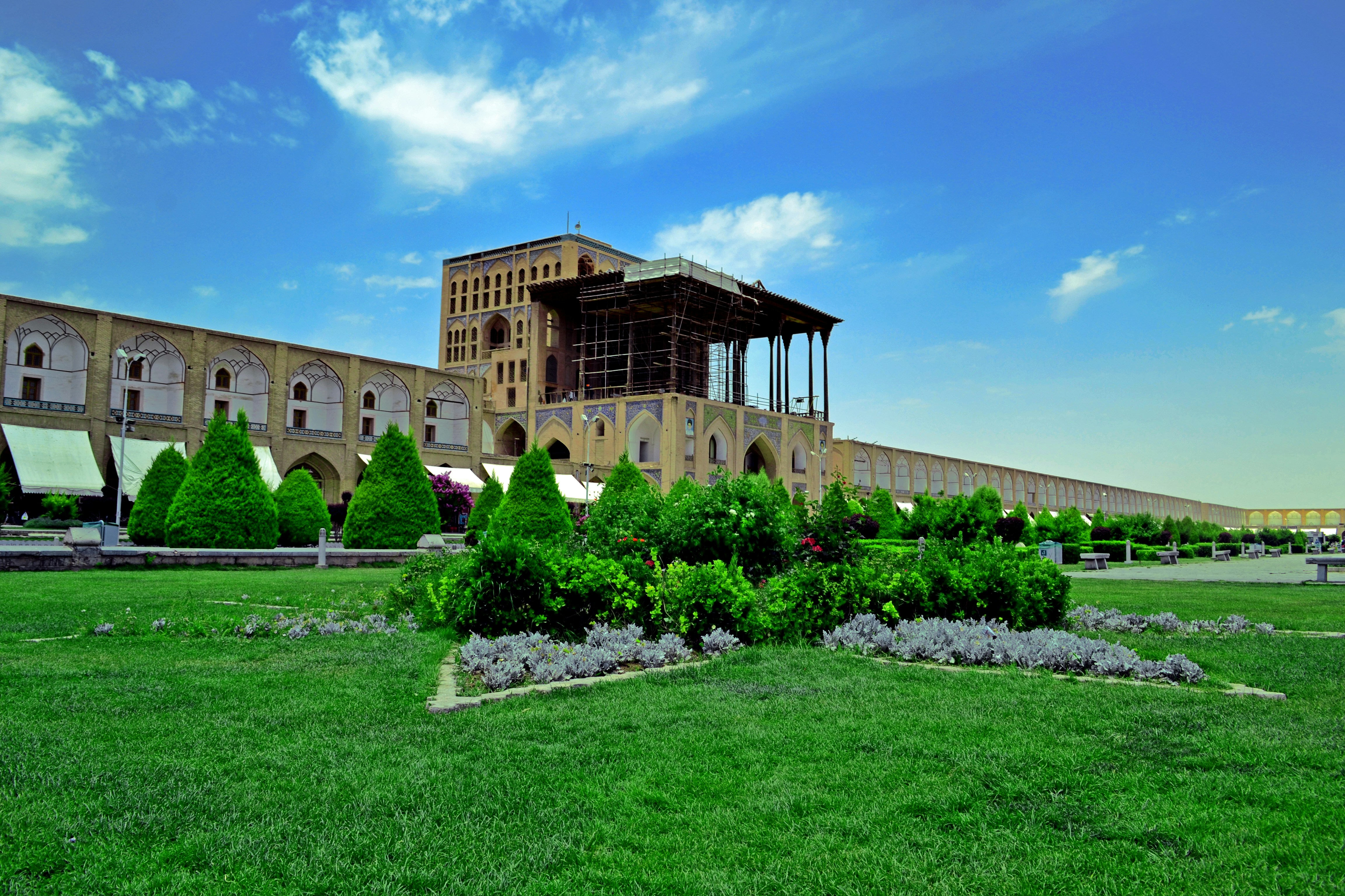 a large building sitting on top of a lush green field