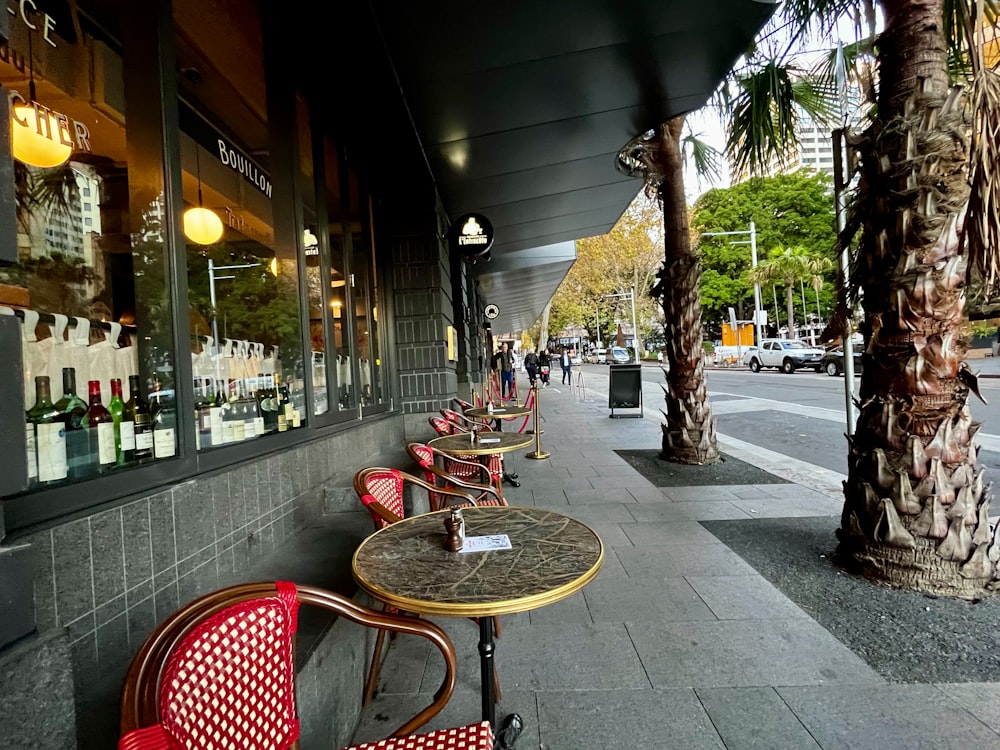 a row of red chairs sitting next to each other on a sidewalk