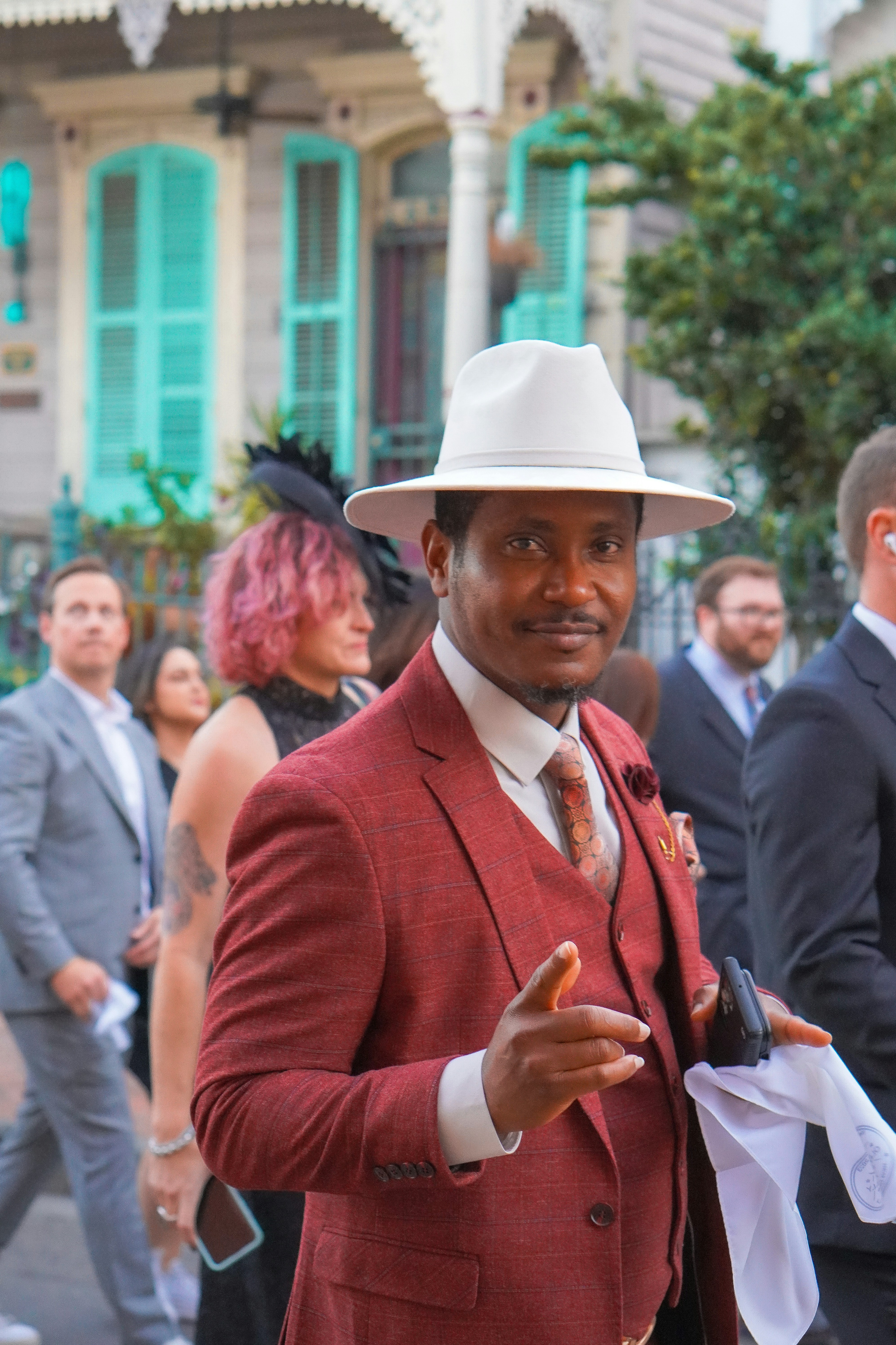 Wedding guest dressed up in a burgundy suit