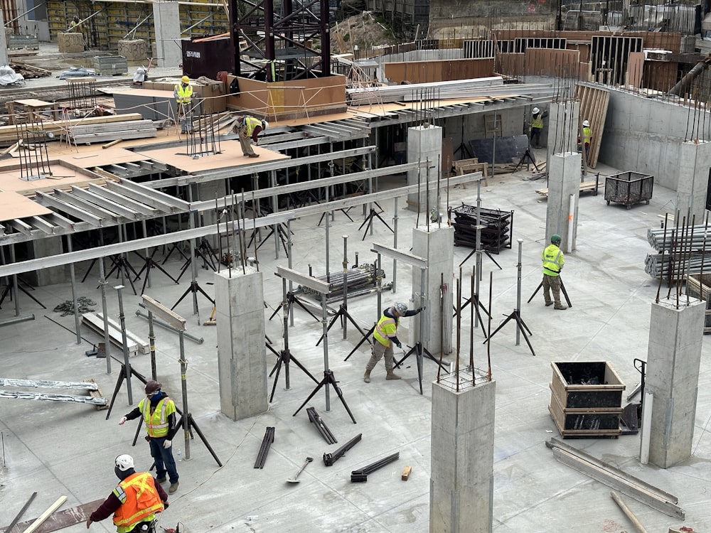 a group of men standing around a building under construction