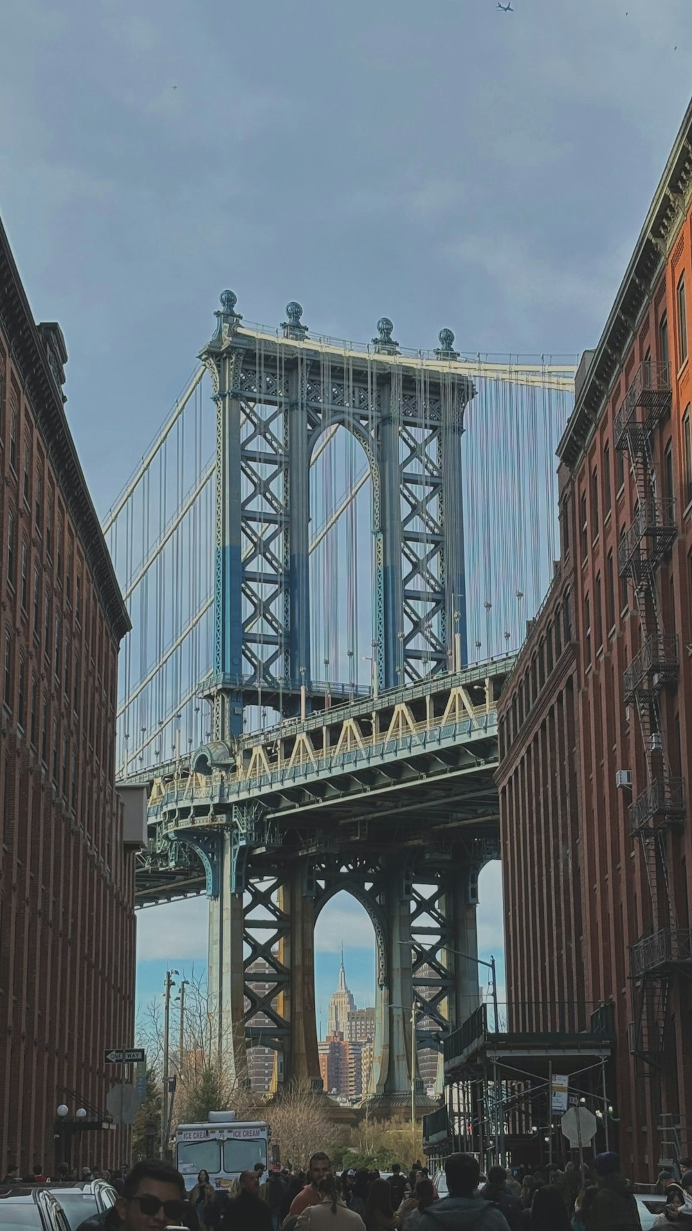 a group of people walking across a bridge