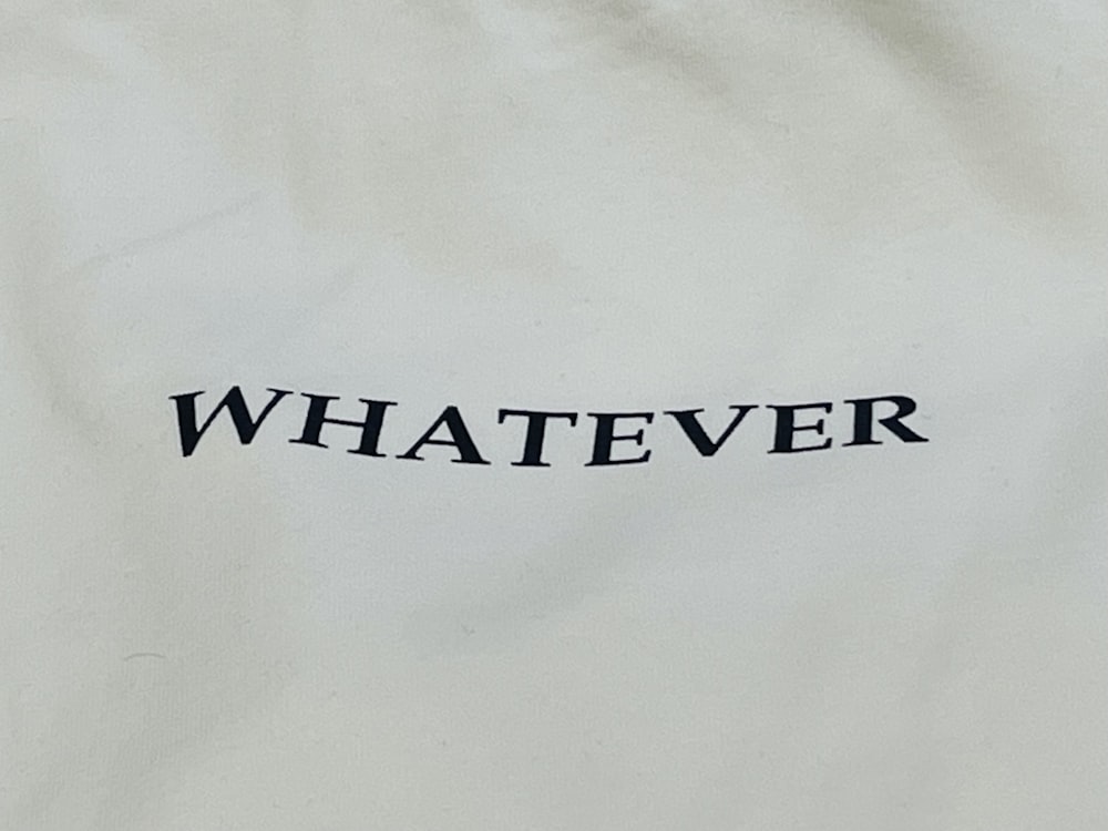 a white bag with the word whatever printed on it