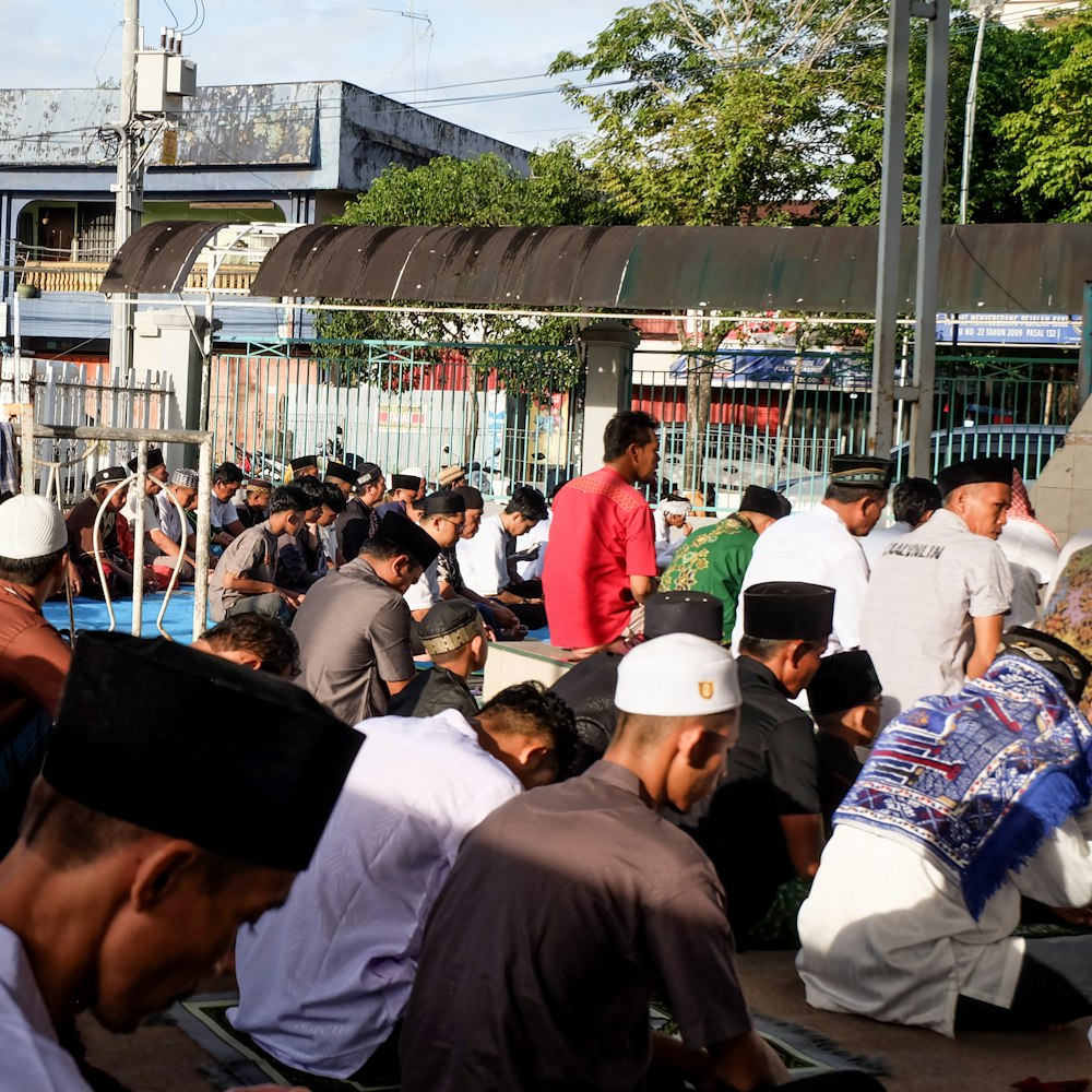 a large group of people sitting on the ground