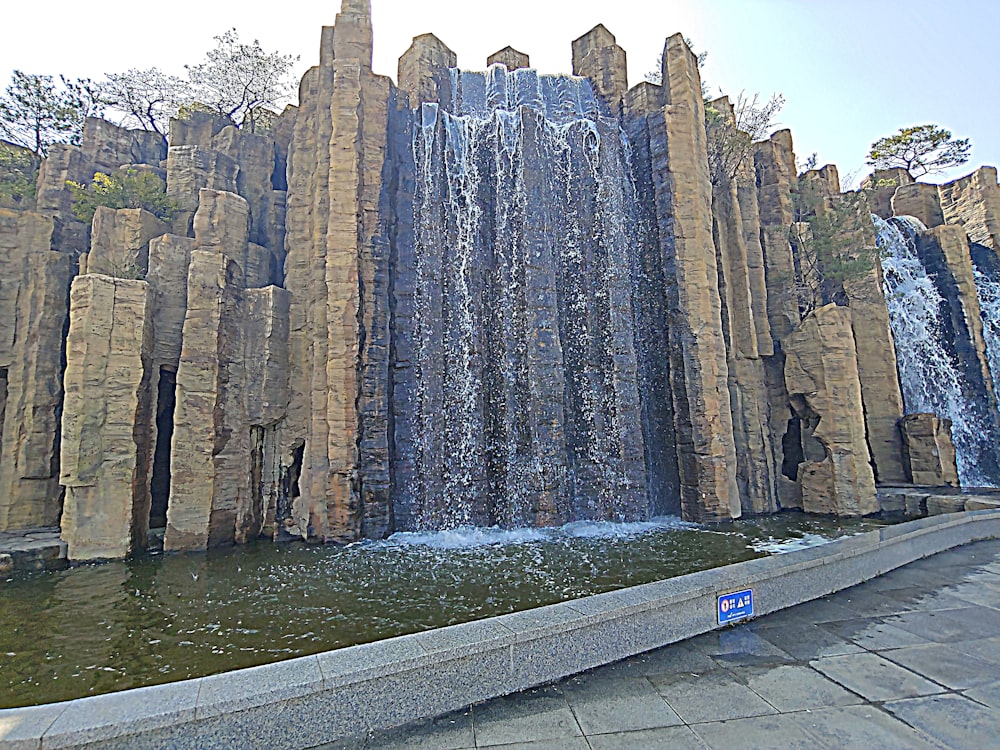 a large waterfall in the middle of a park