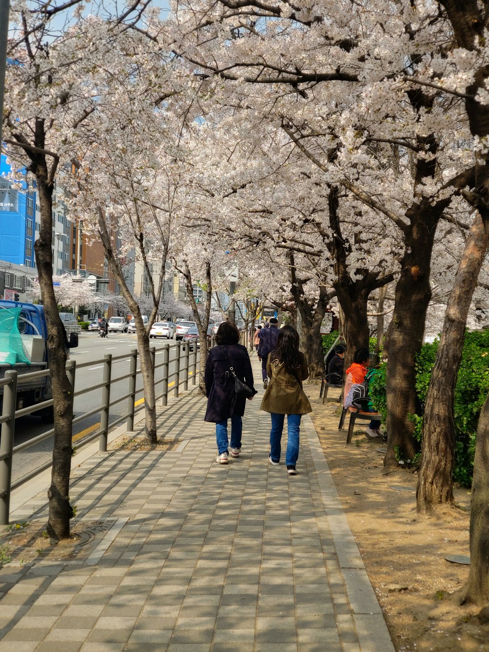 a couple of people that are walking down a sidewalk