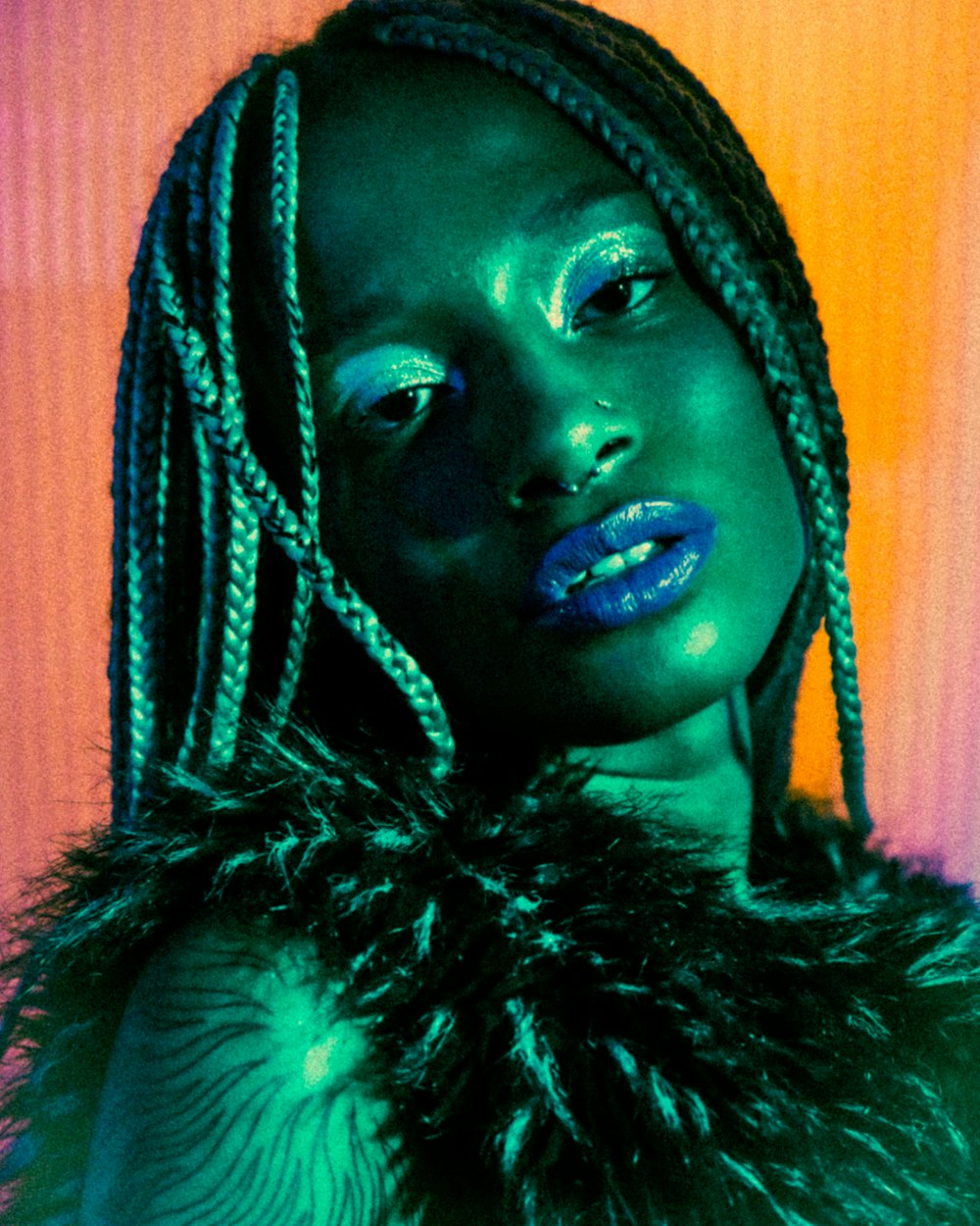 a woman with blue makeup and dreadlocks