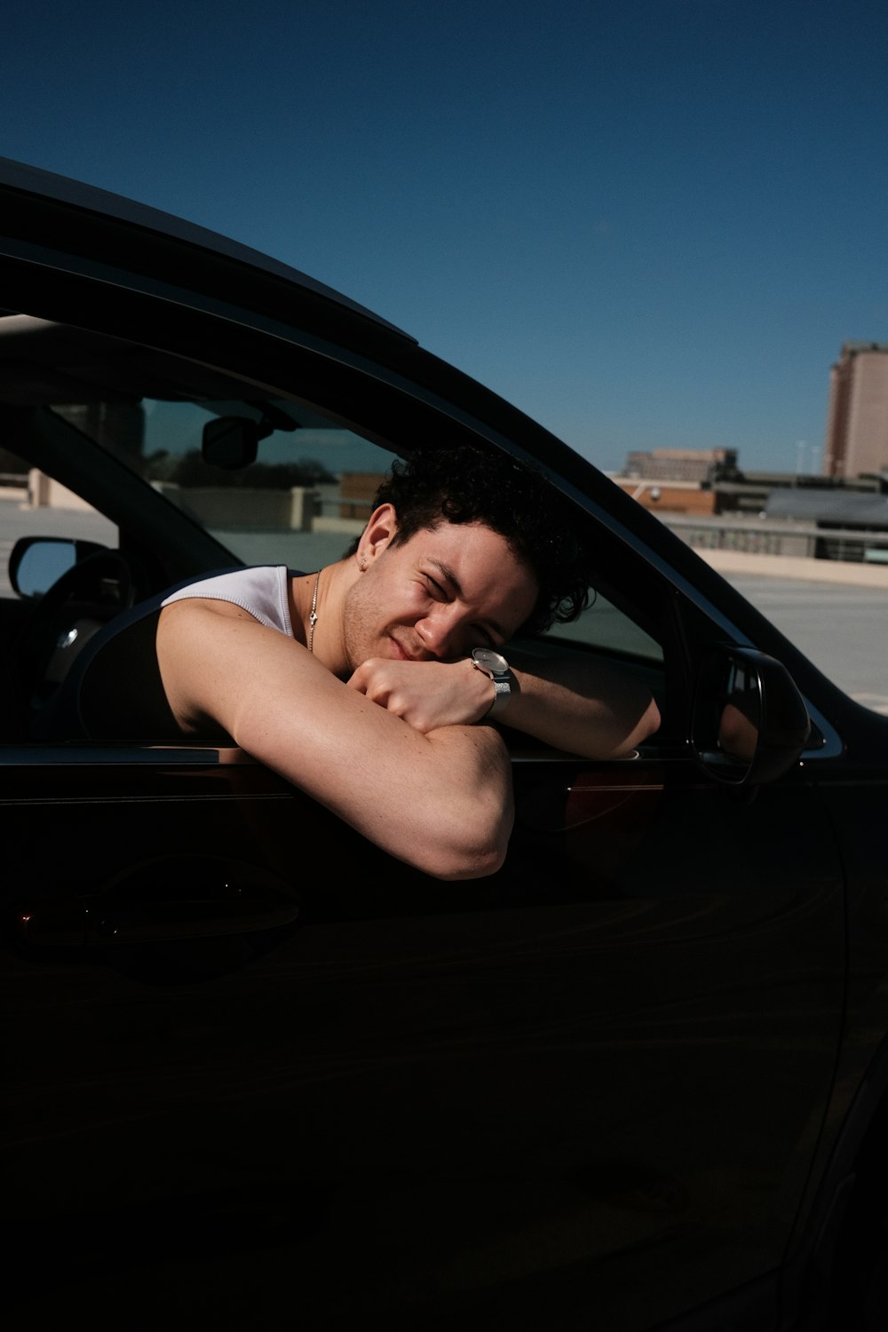 a woman leaning her head out of a car window