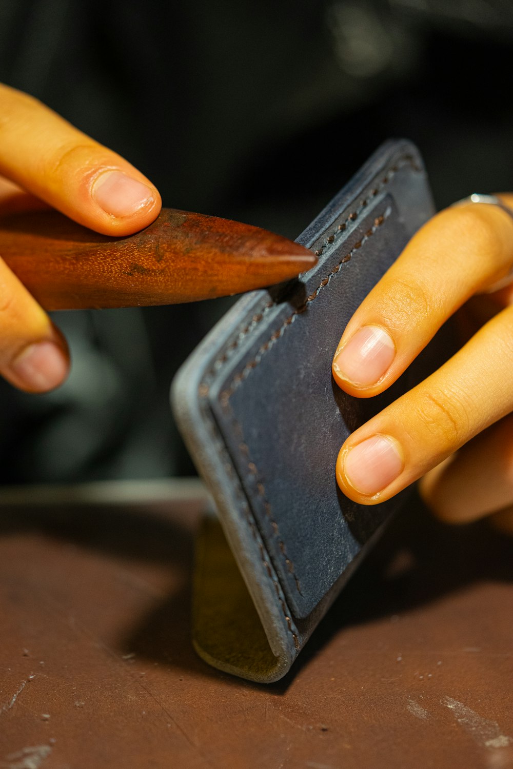 a person holding a piece of wood in their hand