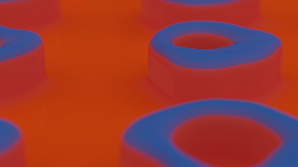 a group of blue and red objects sitting on top of an orange surface